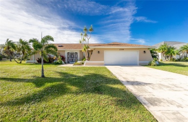 Front Elevation.  Note there is a culvert under the driveway which prevents standing water after it rains.