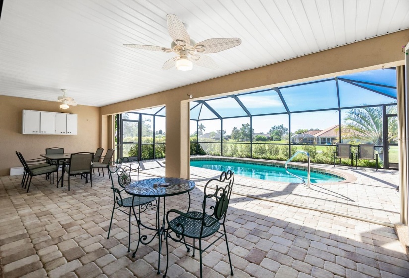 Large lanai with accordion shutters for hurricane protection.  Paver decking.  Notice that view.  Very private with rear neighbors at such a distance.