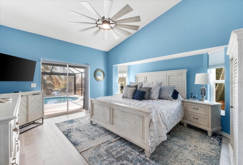 Bright primary bedroom with 8ft sliding doors opening to a sun-soaked deck