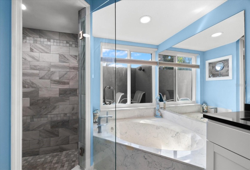 Relaxing bathroom with tile shower and bench