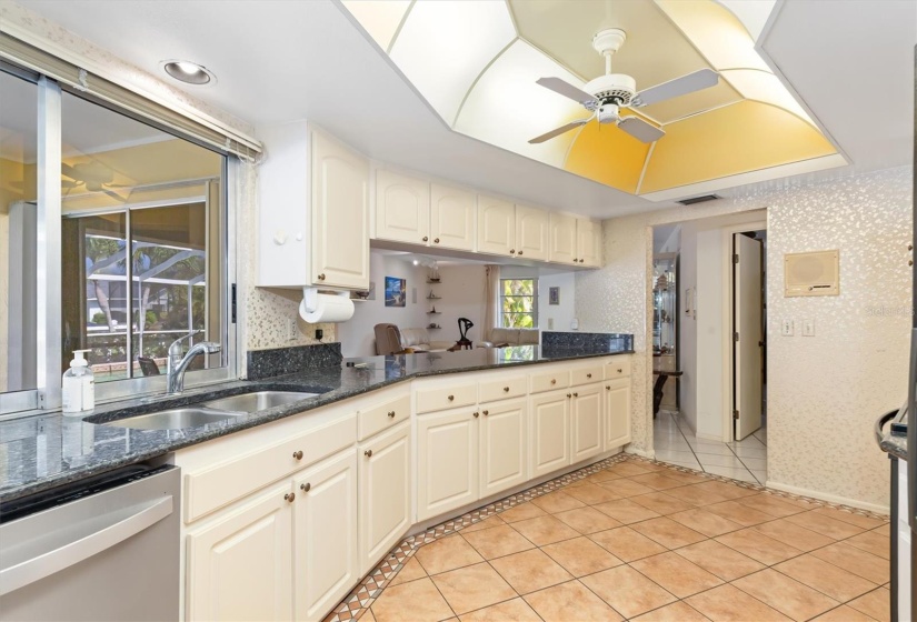 Centrally located, tons of storage and a pass-through window emphasize the functionality of this versatile kitchen.