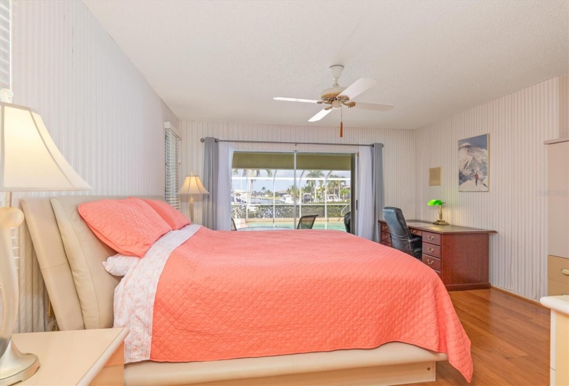 The primary bedroom features hardwood floors.