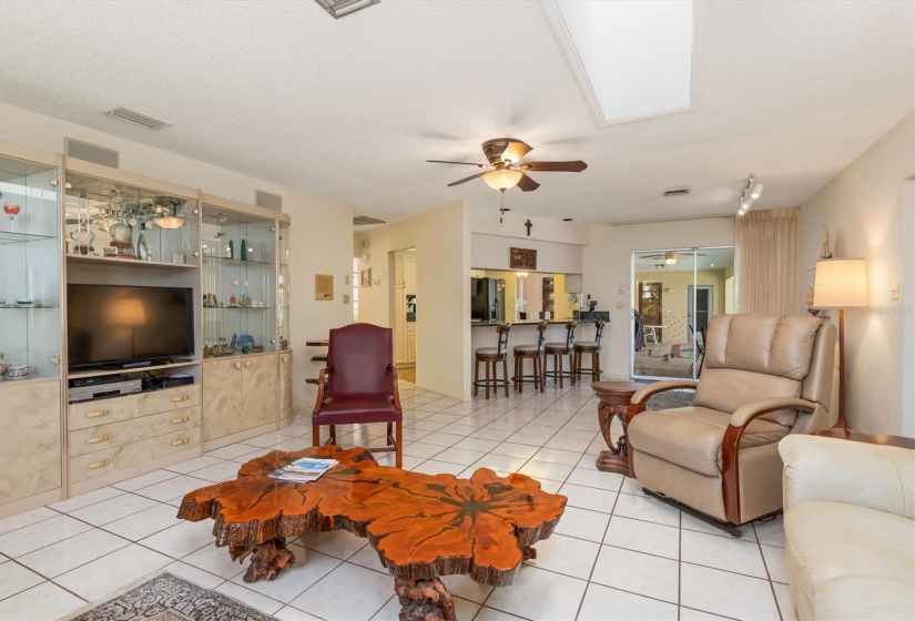 Family room extends past breakfast bar to sliders accessing the lanai for seamless entertaining.