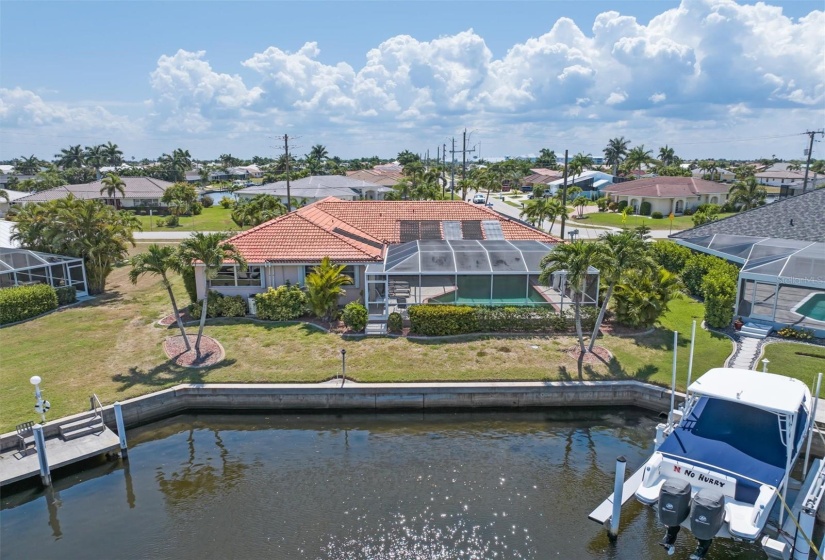 58-feet of concrete seawall and mature landscaping provide privacy and a tropical feel to this canal waterfront property.