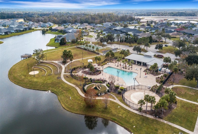 Community Pool with slides, splash pad, outdoor amphitheater and fishing dock.