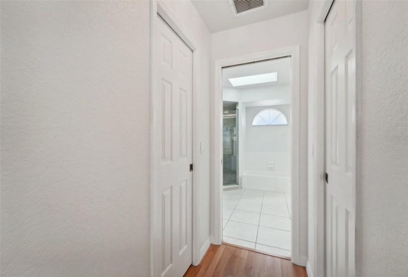 Master bedroom to his and her walk-in closets and master bathroom view