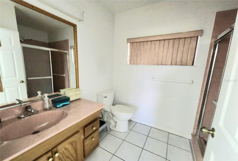 one vanity with commode and walk in shower