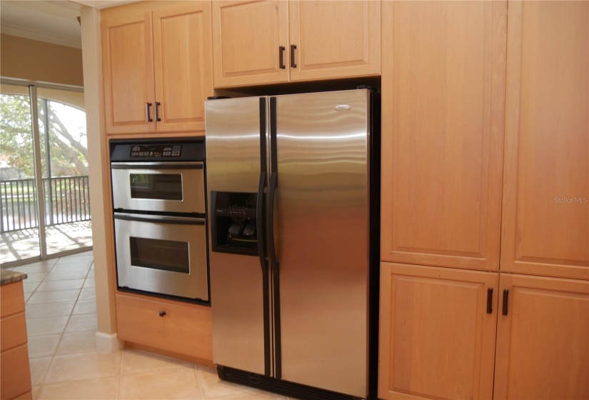 Loads of kitchen storage with this wall of pantries and built-in appliances!