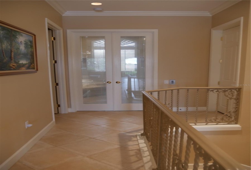 View  from the Great Room to the den, with the powder room on the left and the private elevator to the right!