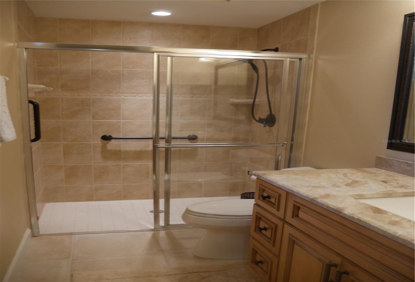 Another roll-in shower for ease entering and exiting in the 2nd full bath!  Grab bars added for safety.