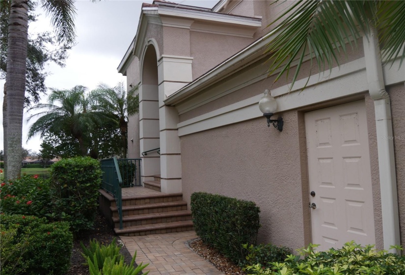 The door on the right goes to your 2-car garage.  The path leads up to the side entry front door.