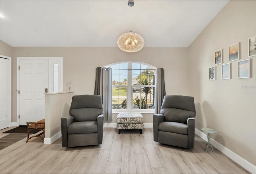 The formal dining room, currently configured as a den, offers flexibility for various uses.