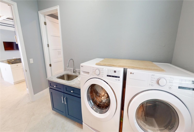 Laundry room off kitchen and primary closet