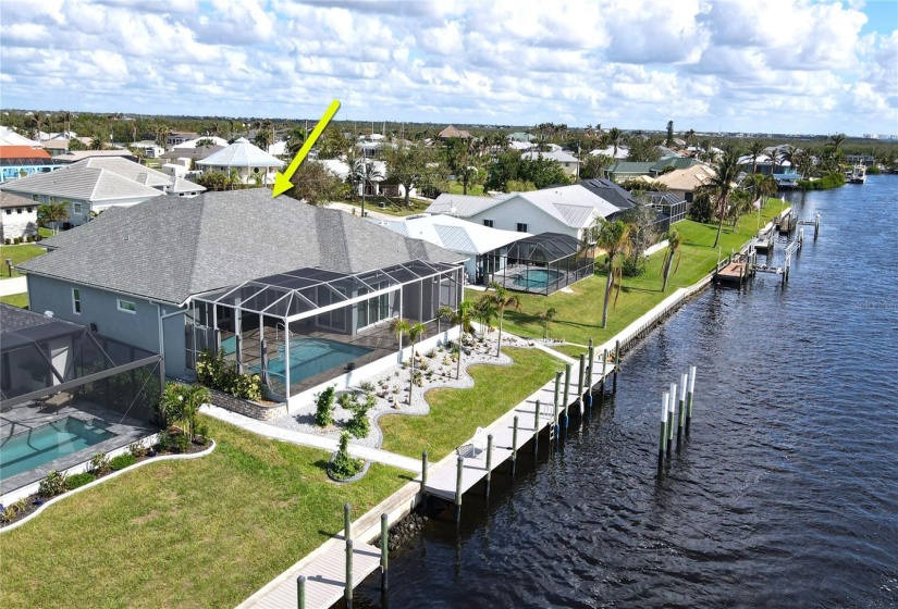 Rear aerial view of home and waterfront