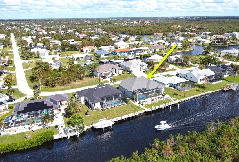 Rear aerial view of home and waterfront