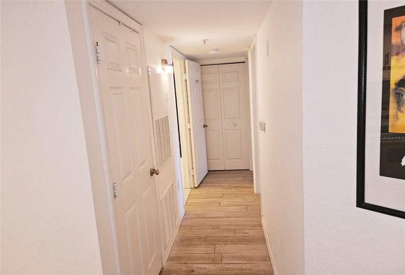 Hallway: Front left, laundry room. Back left, guest bath. Back Right, primary bedroom and bathroom. Near right, guest bedroom.