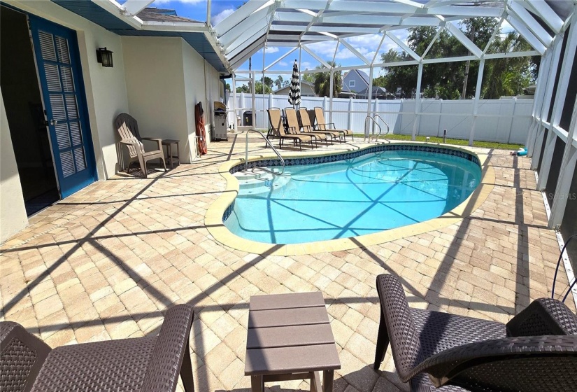 Screened pool enclosure within fenced backyard