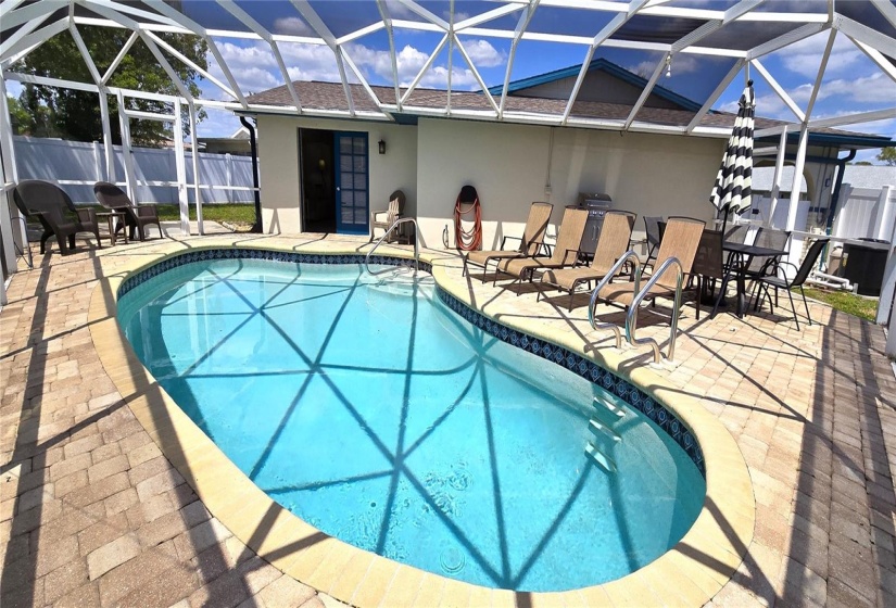 Screened pool enclosure within fenced backyard