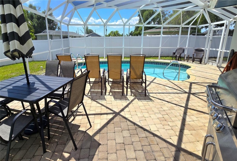 Screened pool enclosure within fenced backyard