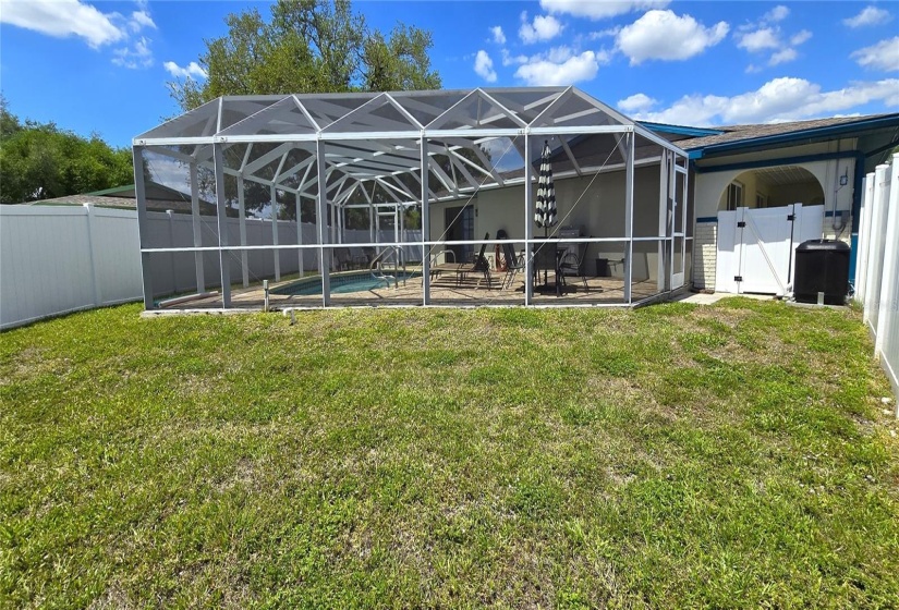 Fenced backyard and screened pool enclosure