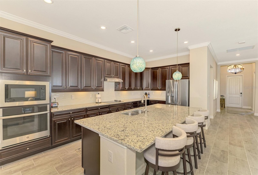 There are volumes of cabinets in the kitchen, a 12' cooking island, casual seating, and a large walk in pantry.