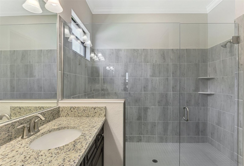 The ensuite bath has dual sinks and a vanity area for make-up