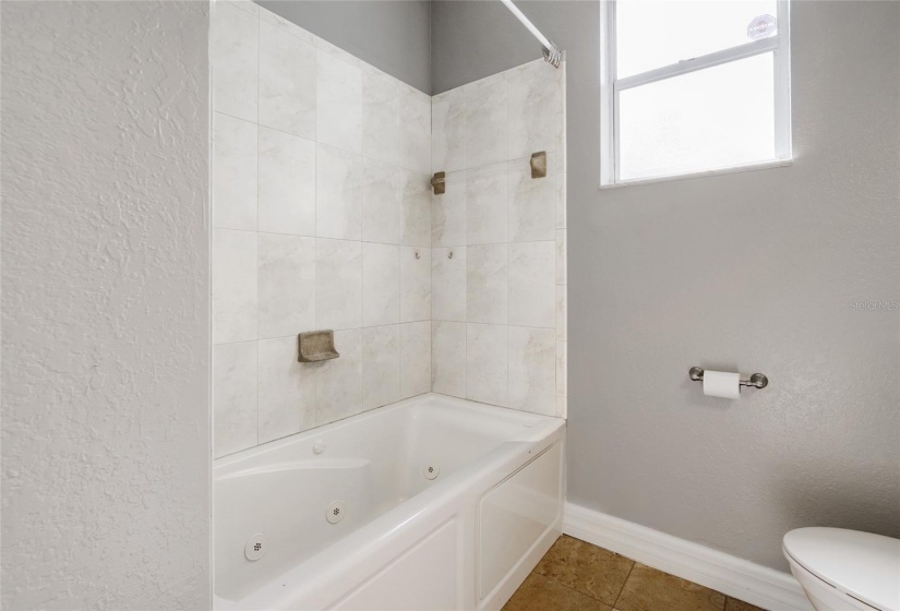 GUEST BATH HAS TUB AND SHOWER FOR KIDDOS AND ADULTS ALIKE.