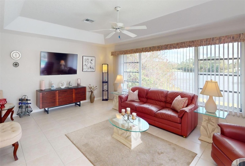 Family room looking from the entry from the kitchen.  Check the windows system overlooking the lake.