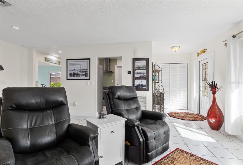 Living area with kitchen and Florida Room in the background.