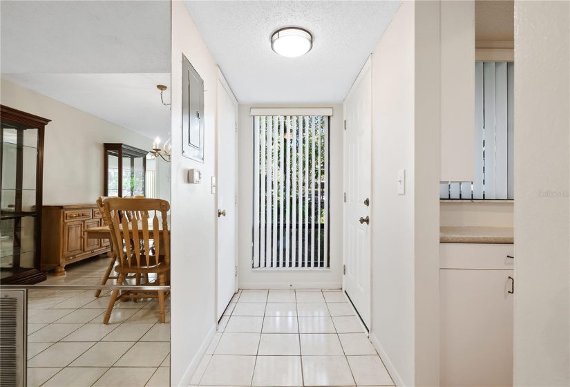 Tiled foyer with extra storage closet