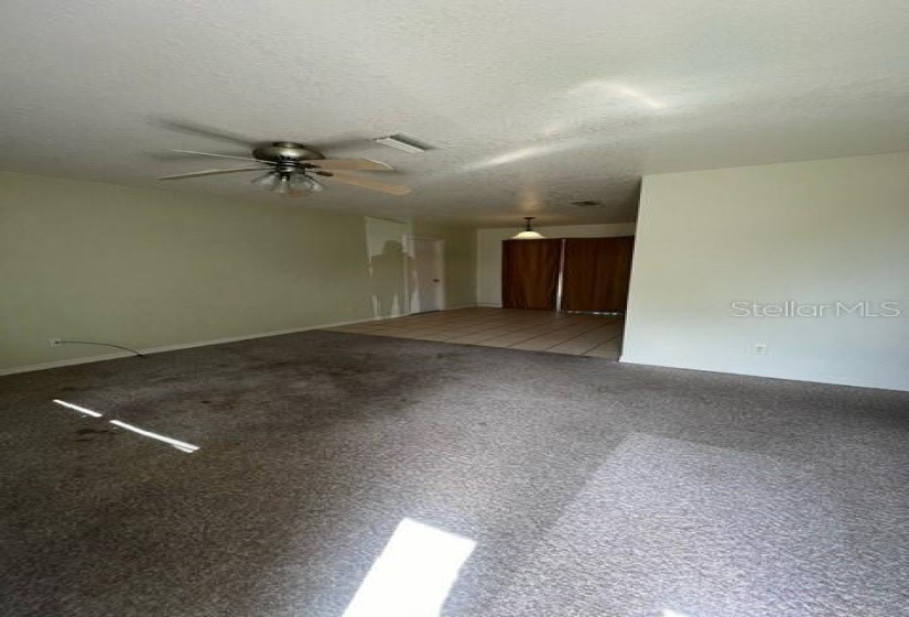 Living area looking towards Dining and sliding glass doors.