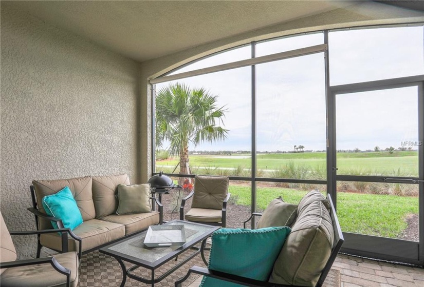 View of golf course and water beyond.