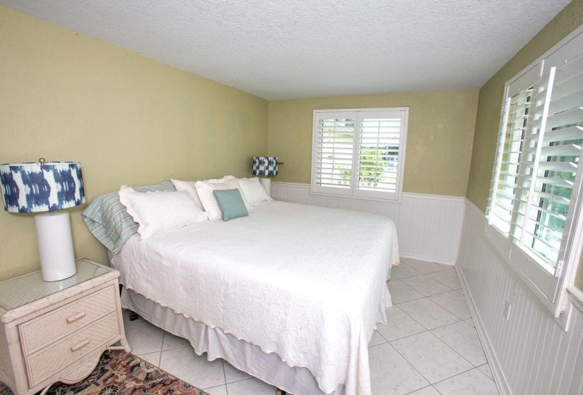 plantation shutters and beadboard walls over concrete HARDY BOARD add to coastal decor in master bdrm. no furniture