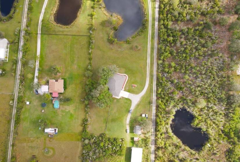 Aerial of property with pond, house, guest house, chicken coop and barn