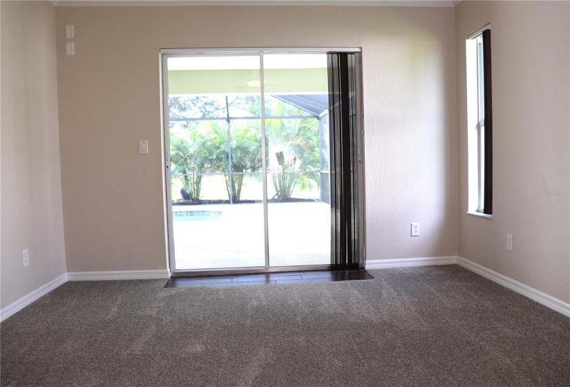 Primary Bedroom with view of pool