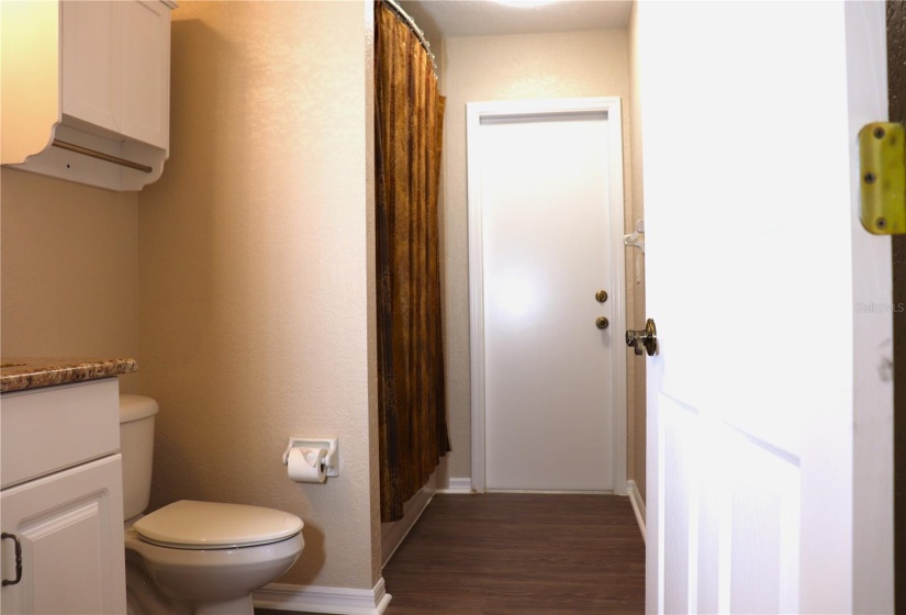 Guest / Pool Bathroom with door leading to Pool