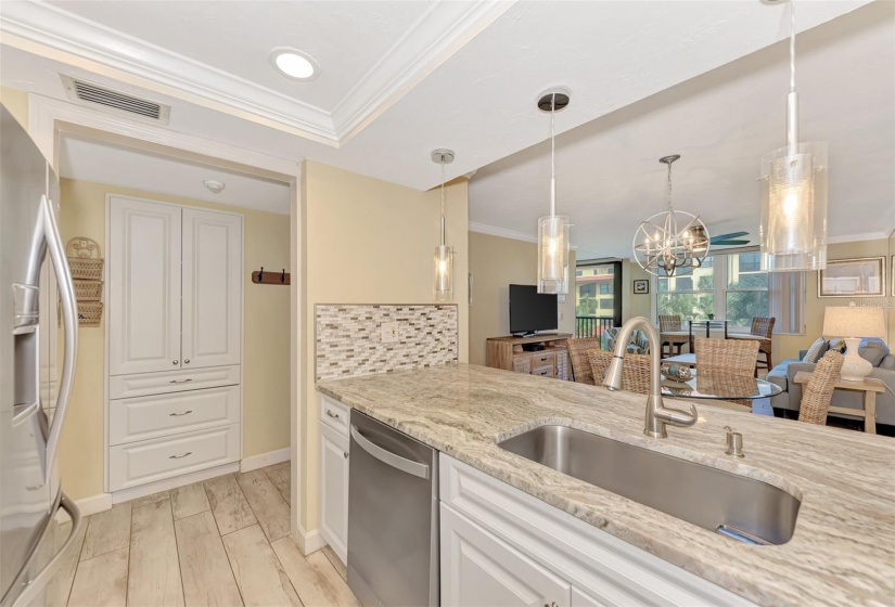 Granite, backsplash and pendulum lights