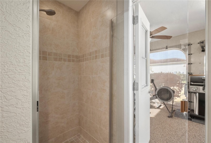 Master bath shower with glass door, and access to lanai & pool