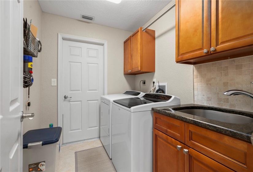 Updated laundry room with extra storage and deep laundry sink