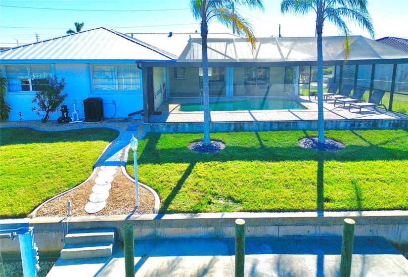 The palm trees are the ideal backdrop for this saltwater front beauty