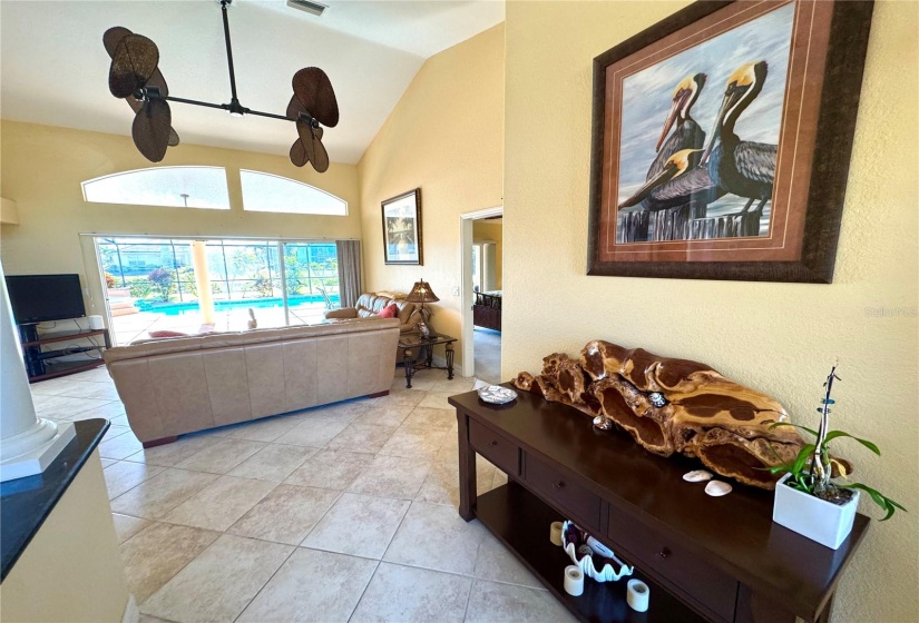 Modern coastal vibes ceiling fan and soaring vaulted ceilings!