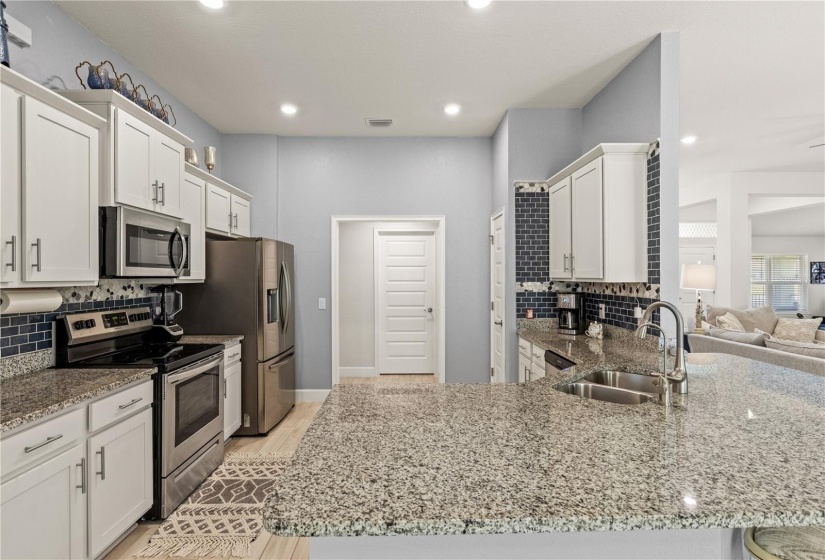 The kitchen features a large breakfast bar