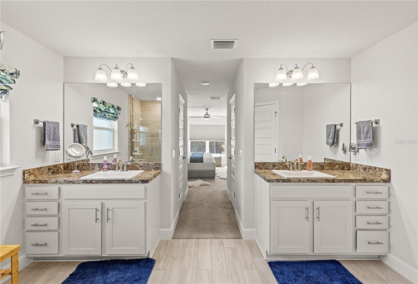 Owner's ensuite bathroom featuring dual vanities.