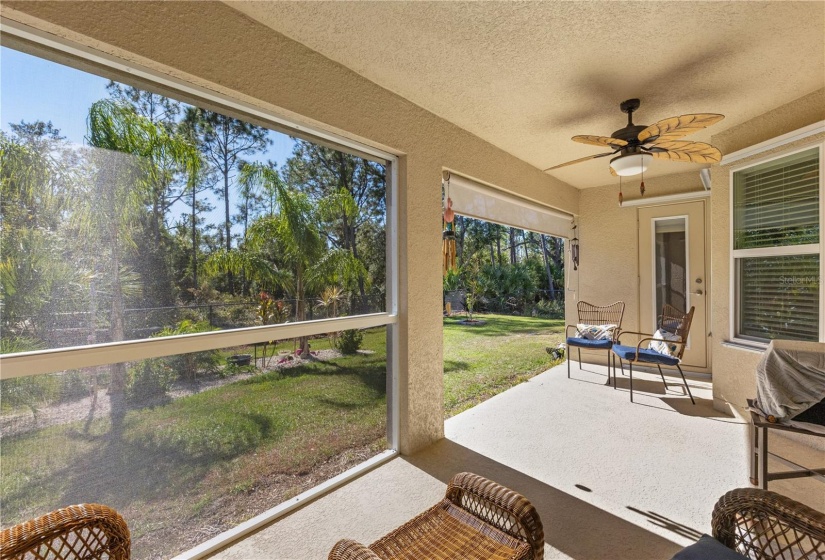 Large covered lanai with views of the fenced-in back yard.