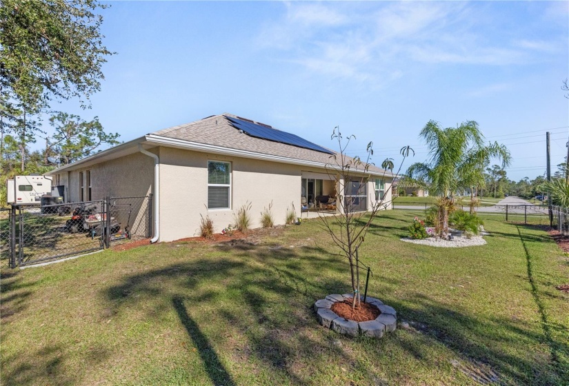 Mature tropical landscaping adds a beautiful touch to the back yard.