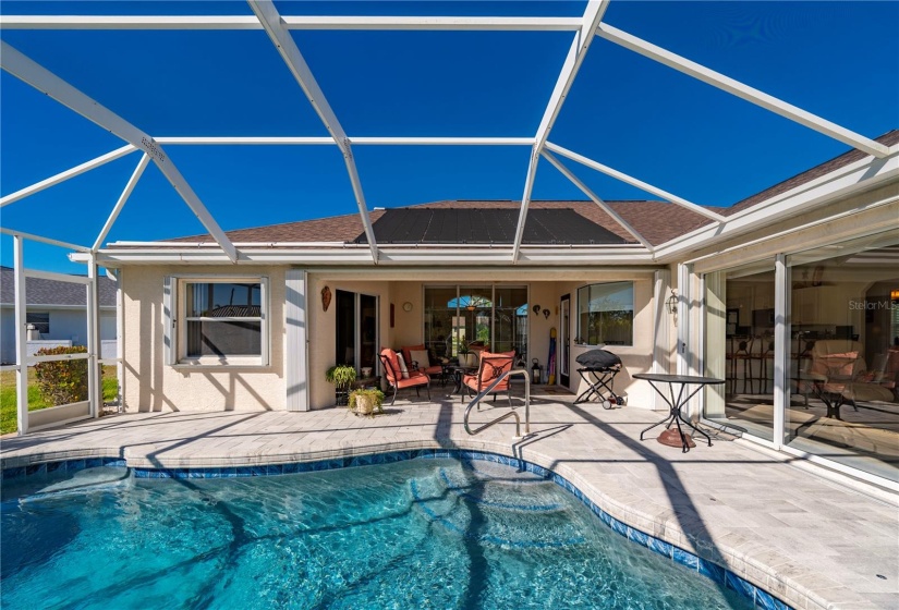 Pool has seated spa area