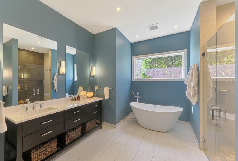 Stunning primary ensuite bath with soaking tub, stand alone shower and dual vanity.