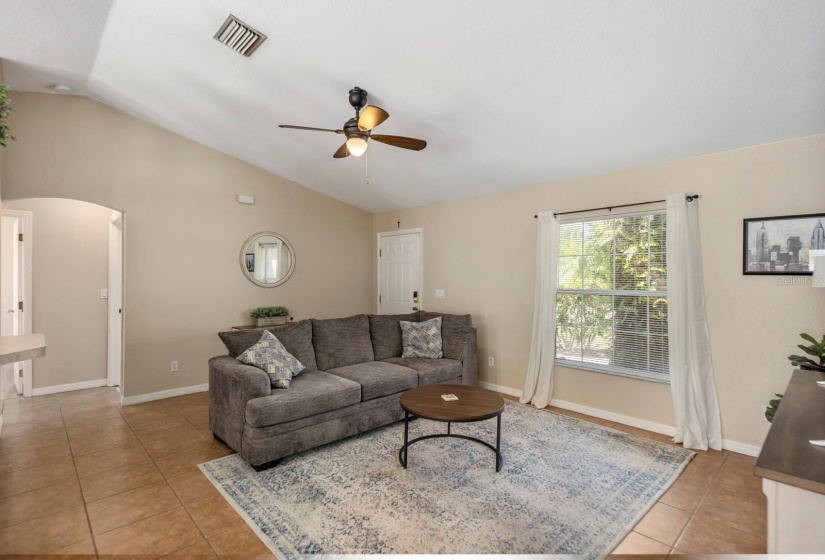 View of the living room from the dining room; open doorway leads to the guest bedrooms and bath