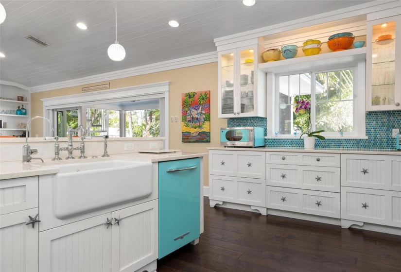 Kitchen with sliders to screened lanai for alfresco dining