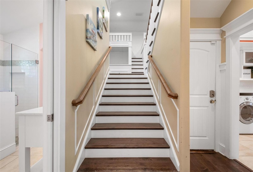 Stairway to second level, laundry room and entry to garage